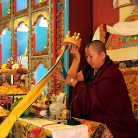 Jets&uuml;n Khandro Rinpoche receives a mandala offering.