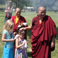 Jets&uuml;n Khandro Rinpoche visits with youngsters Lily Baker and Sofina Davis at Lotus Garden.