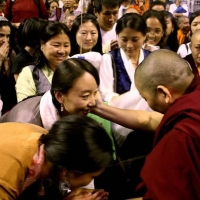 Jetsün Khandro Rinpoche surrounded by audience members after her teaching on bodhicatta. Kalachakra empowerments with His Holiness the Dalai Lama. August 2011, Verizon Center, Washington DC