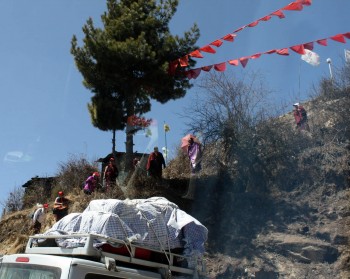 Rinpoche and Jetsunla begin the climb up Chödrak Cliff.