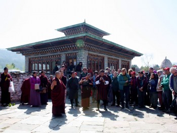 Jetsün Khandro Rinpoche looks on as the tour coordinator, Tenpa Choephel la expains the history of the region.