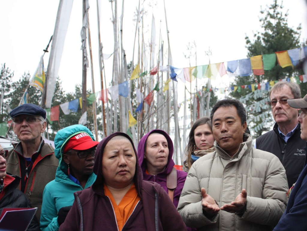 Tenpa Choepel la, the tour coordinator, speaks to the group.