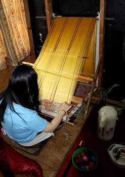 Weaver at her loom in the textile centre.